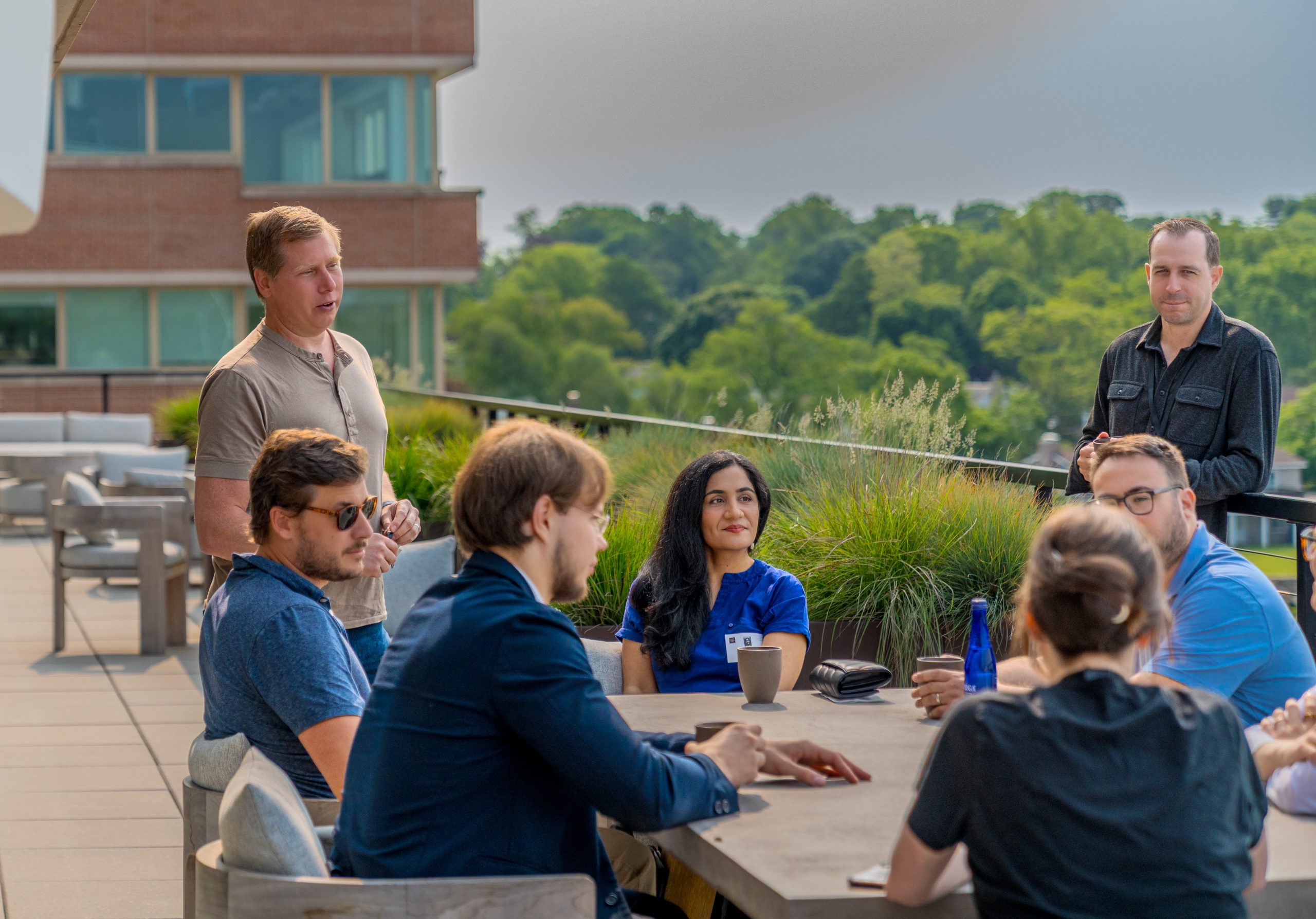 UConn students and alums meet with Yuma employees in an outdoor seating area.