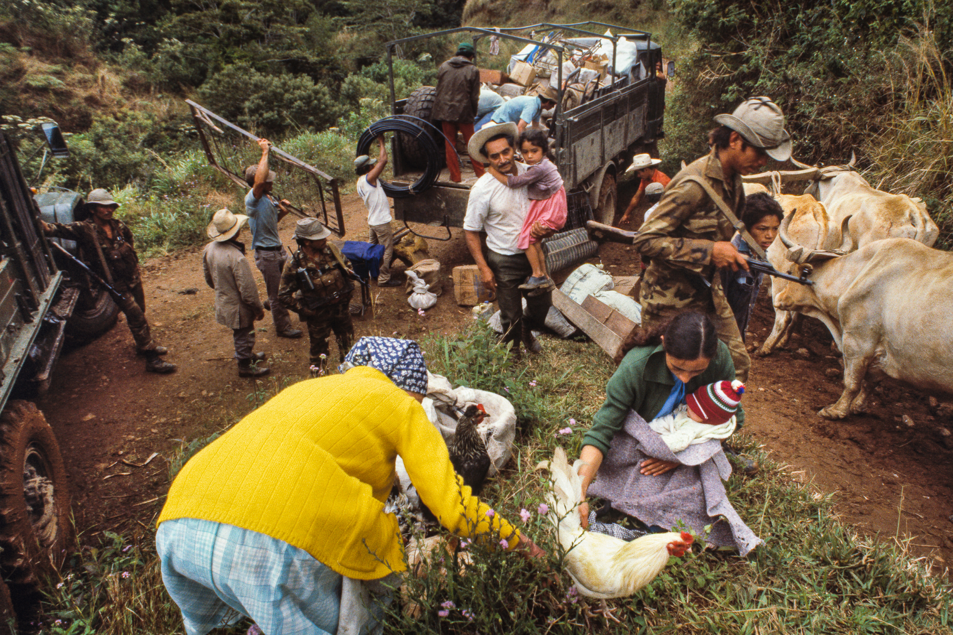_1985_Ventarron A busied scene of people and farm animals with a soldier standing nearby.