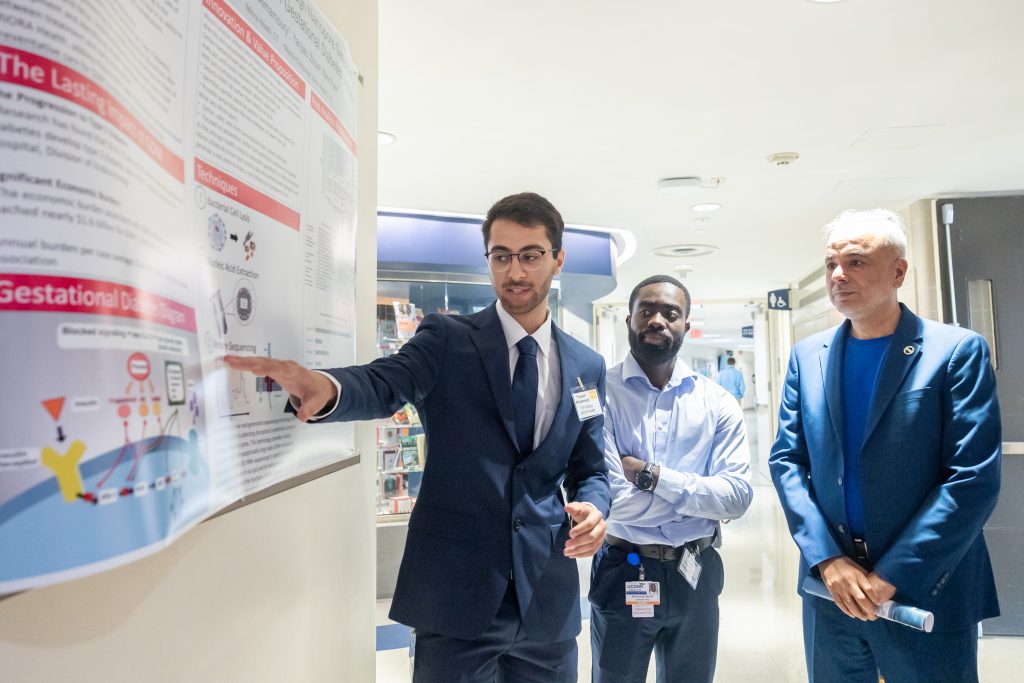 Student researcher showing research project