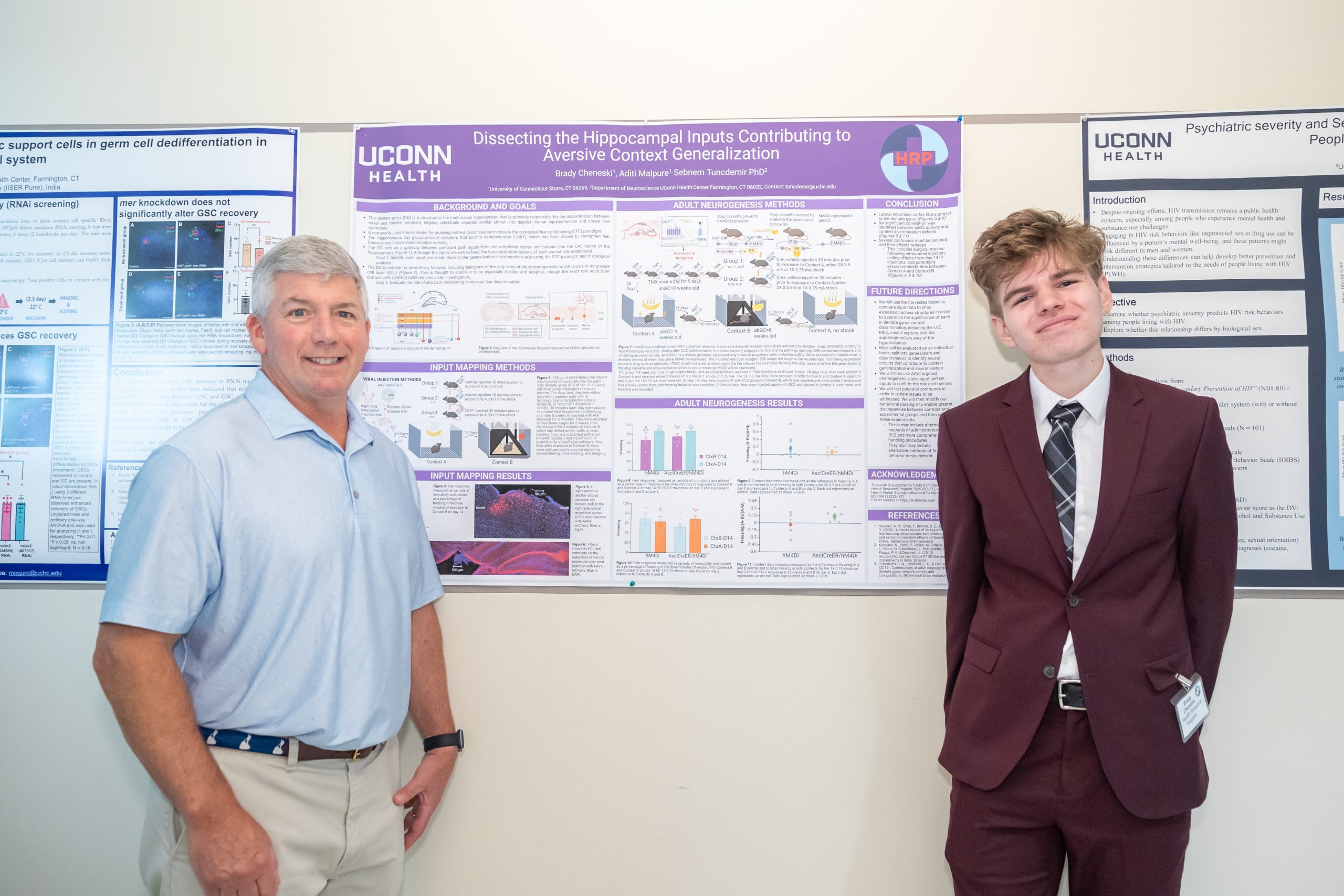 Two men standing infront of research poster