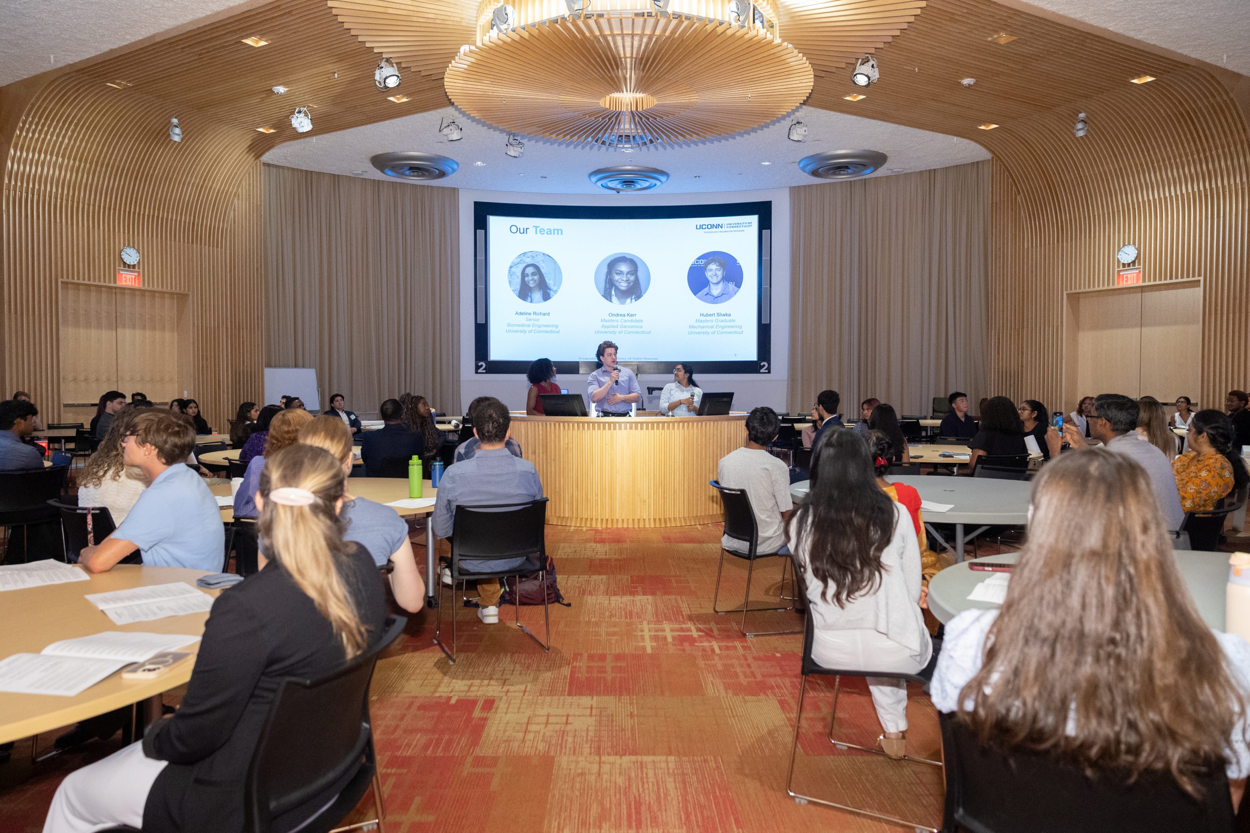 student presents research to large group