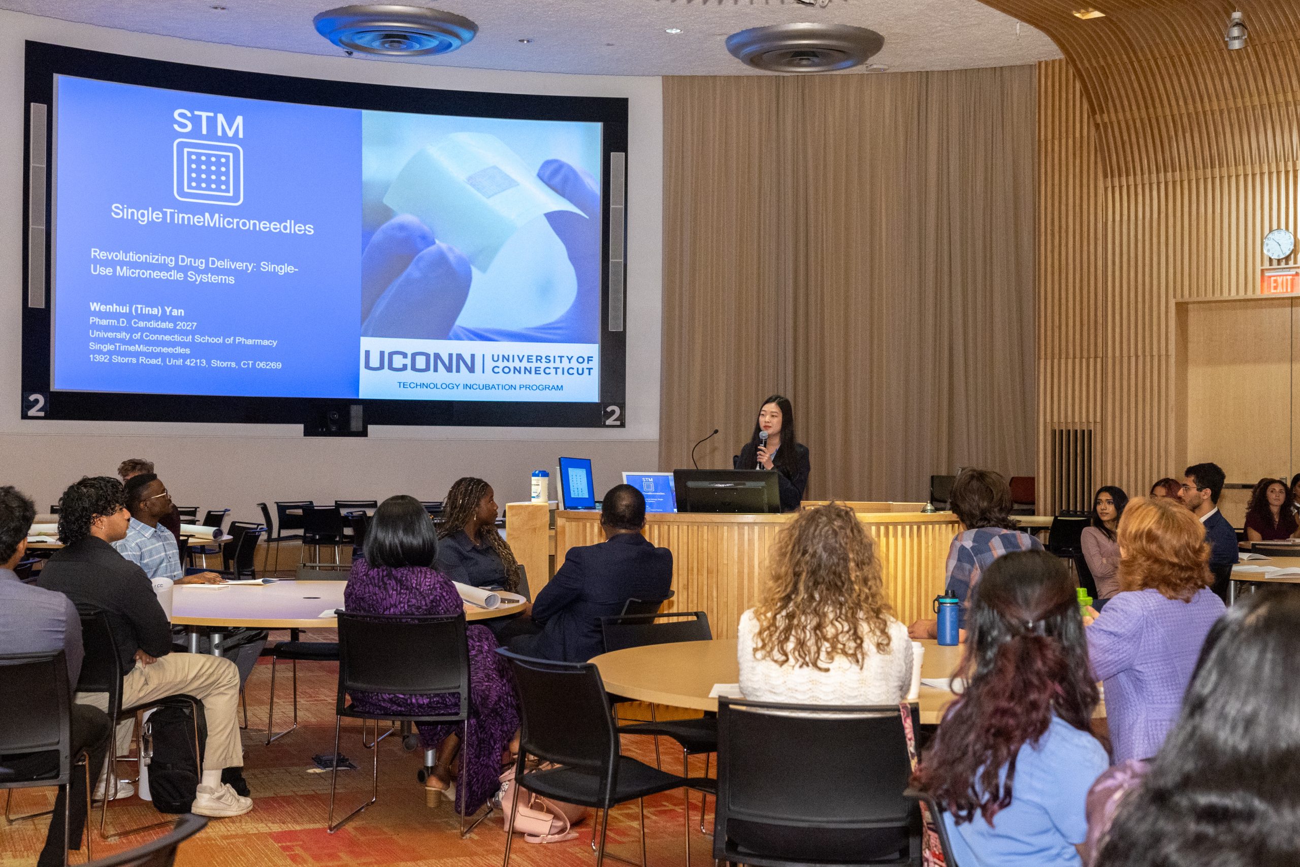 student presents research to large group