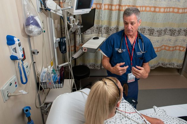 Dr. Robert Fuller with patient in emergency department bay