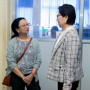 Two women speaking indoors