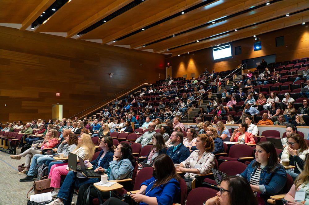 Conference attendees listen to presenters during Teaching and Learning with Technology conference.