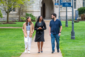Eboni Nelson walks with two students