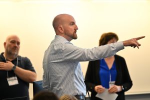 Male professional points during a presentation.