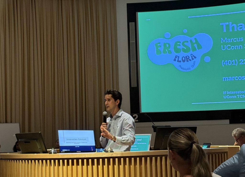 Class of 2027 UConn dental student Marcus A. Costa talking to investors about his healthy chewing gum invention. (Photo by Lauren Woods)