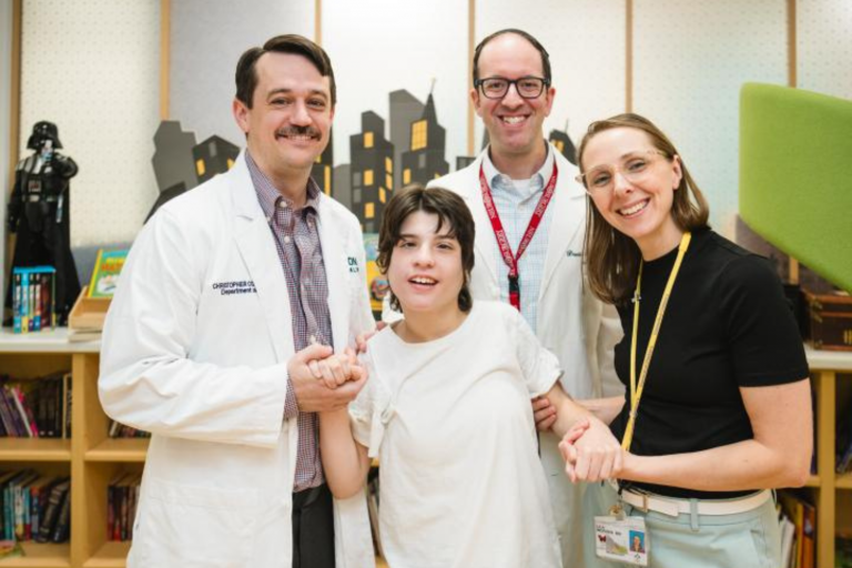 Dr. Chris Conner talking to patient Bella and pointing to camera