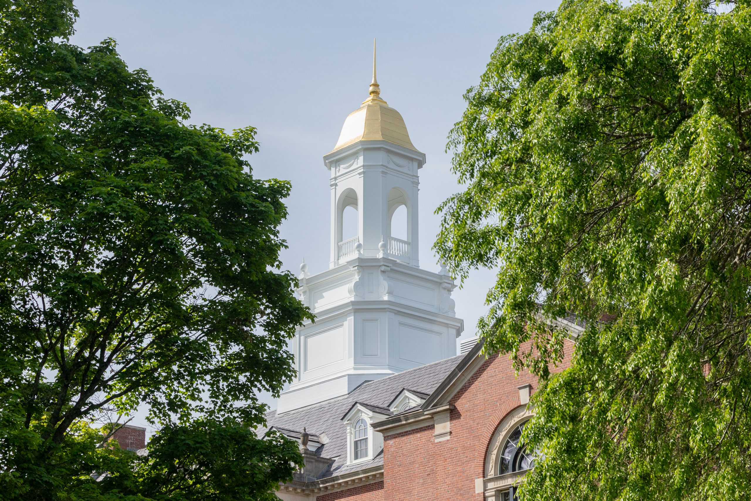 The Wilbur Cross cupola sits on a summer day surrounded by green trees