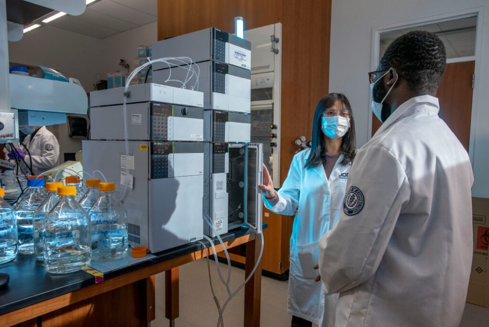 Xiuling Lu with graduate students at her lab in the School of Pharmacy. Jan. 26, 2022. (Sean Flynn)