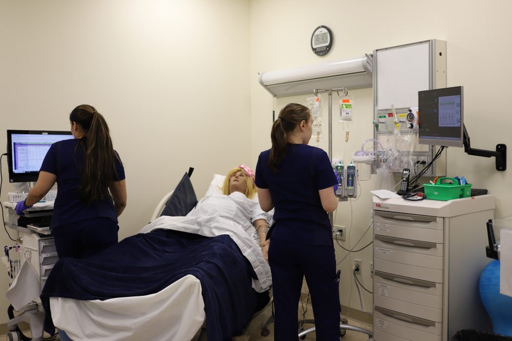 UConn School of Nursing students in the simulation lab with a high-fidelity maternity mannequin on April 4, 2025.