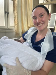 Audra Porowski holding a newborn baby on the Experiential Global Learning Program in Rwanda.