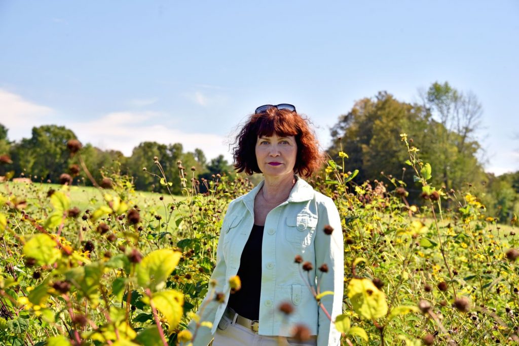 Julia Kuzovkina of the Department of Plant Science and Landscape Architecture (PSLA) poses for a portrait with wildflowers at the Plant Science Research and Education Facilities also called the Plant Science Research Farm