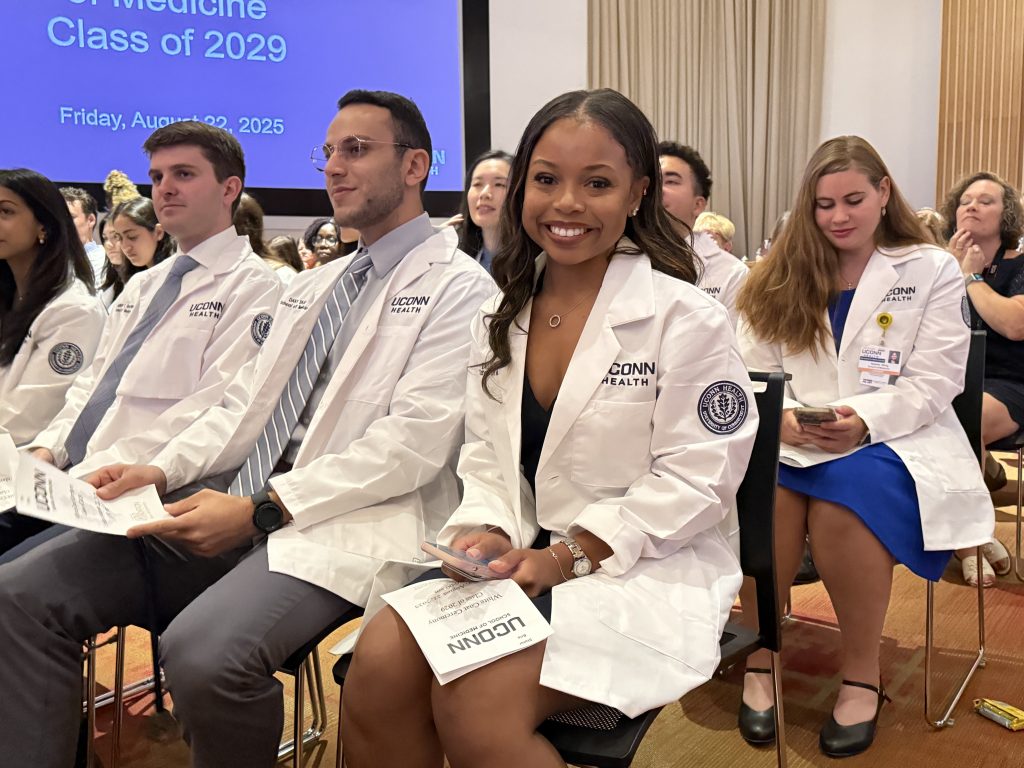Ecstatic Bria Slater is excited for her brand new white coat and to start UConn medical school (Lauren Woods/UConn Photo).