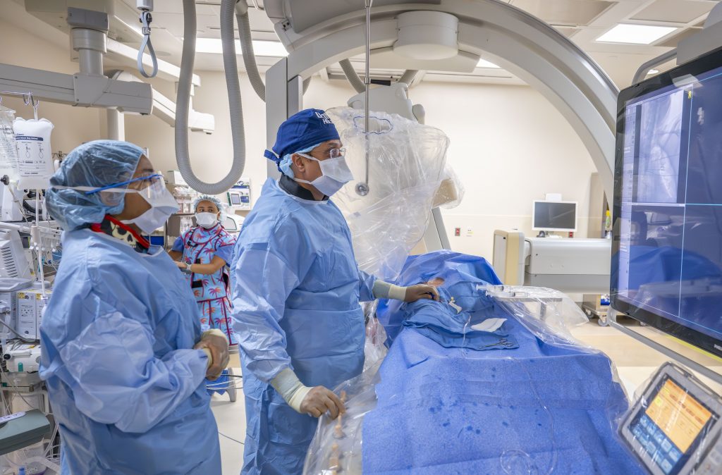Neurosurgery resident Dr. Burch looking on as Dr. Bulsara operates.