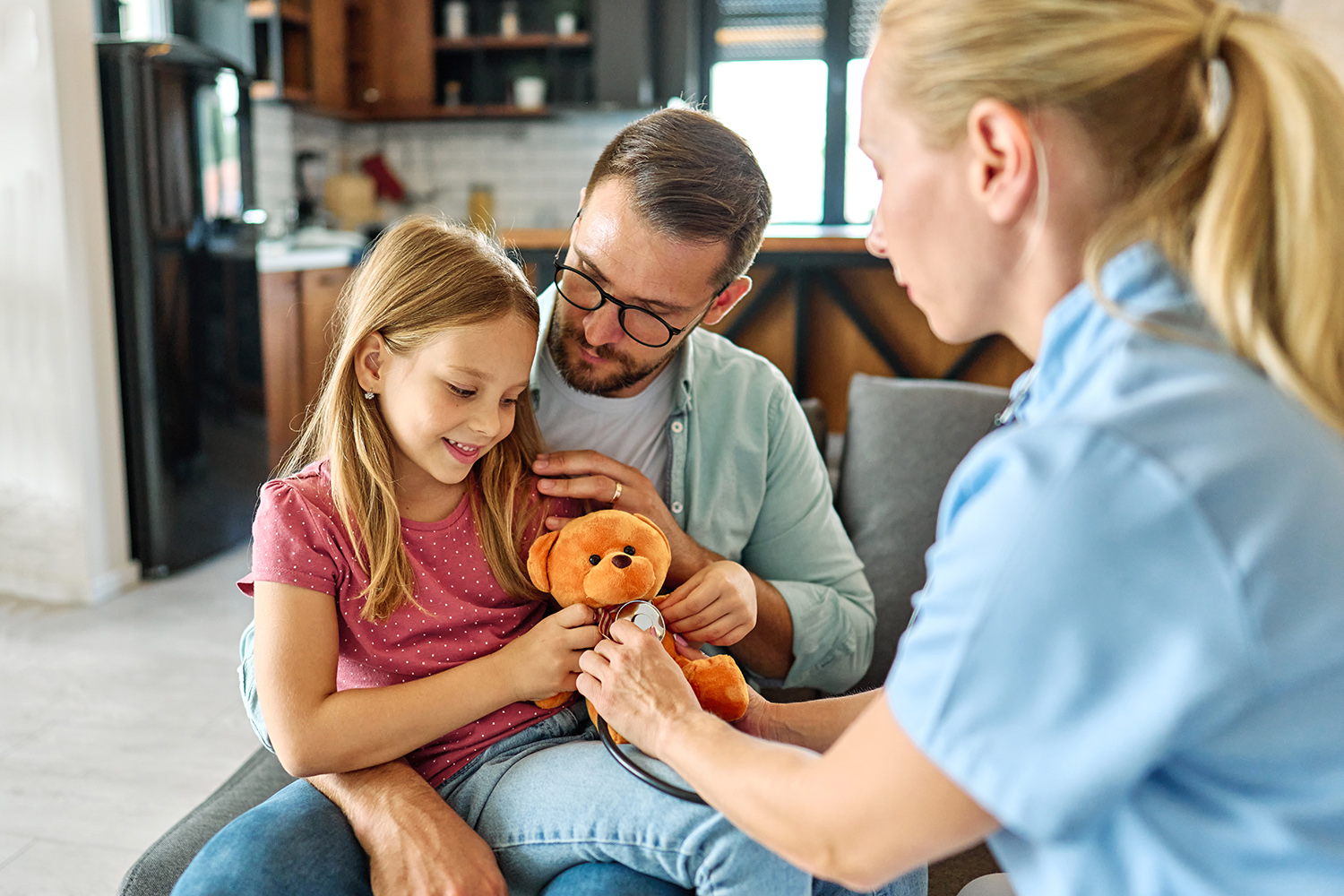 Father holds sick child and nurse
