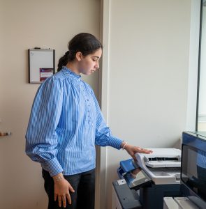Noor Hassan making copies at a printer