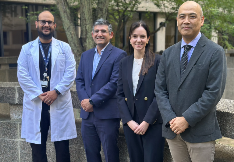 four dentists standing in courtyard