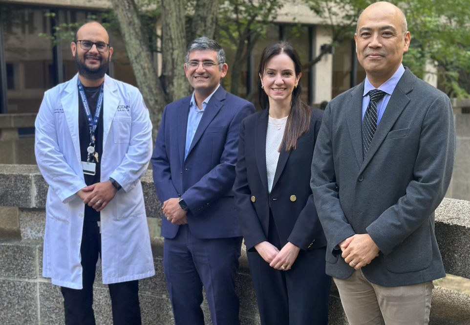 four dentists standing in courtyard