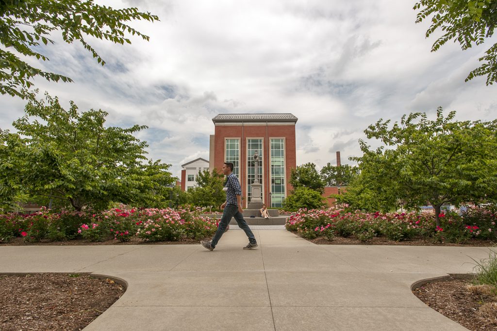 The Charles B. Gentry Building as seen from the Rowe Building at UConn Storrs. A man walks by in the foreground.