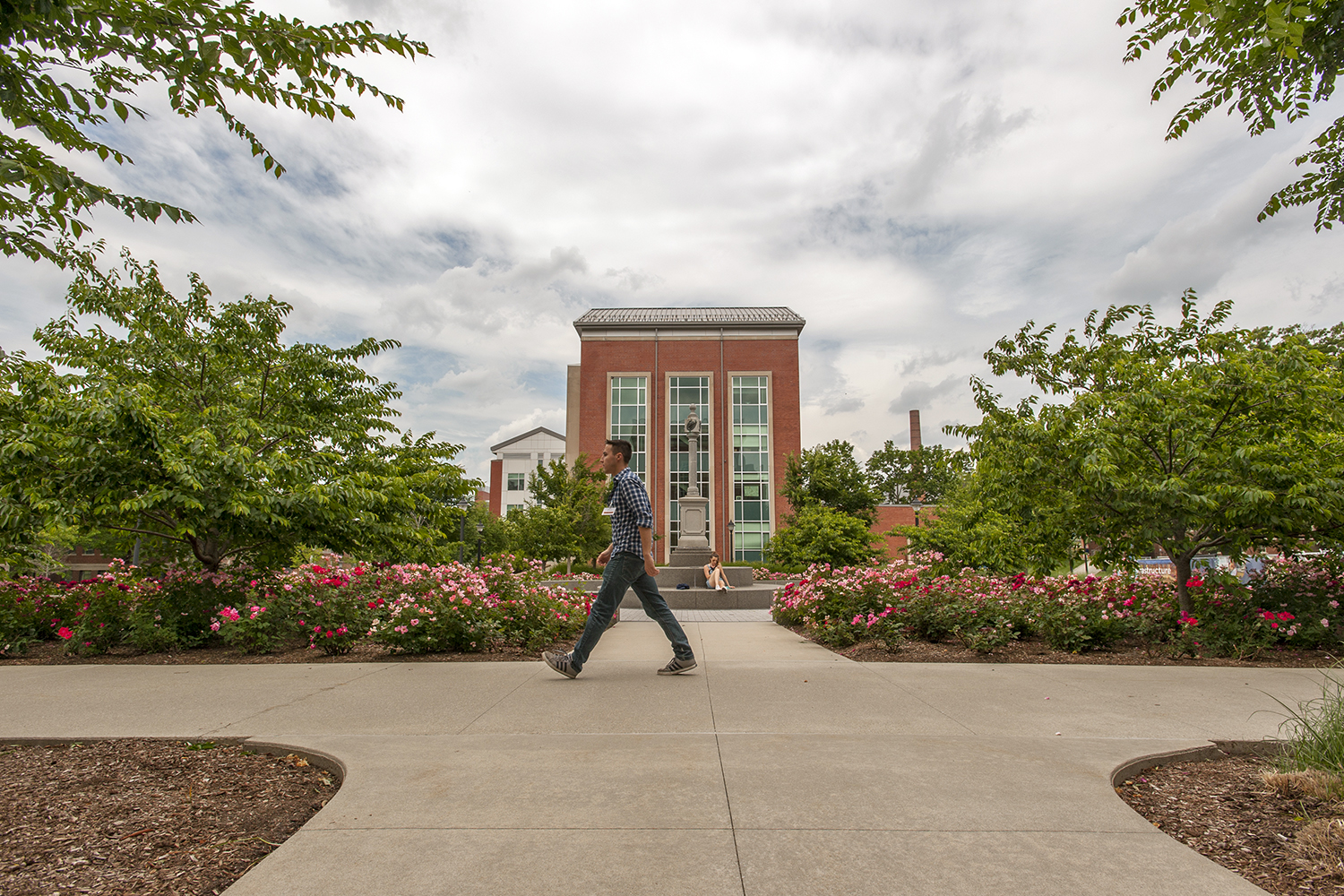 The Charles B. Gentry Building as seen from the Rowe Building at UConn Storrs. A man walks by in the foreground.