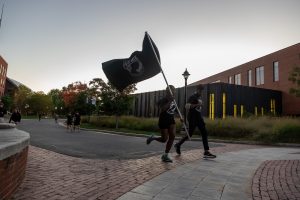 UConn Air Force and Army ROTC cadets carry the POW/MIA flag around campus