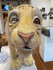 An up-close picture of the snout of a tiger puppet.