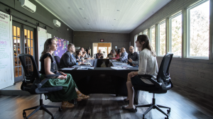 People sit at a conference table.