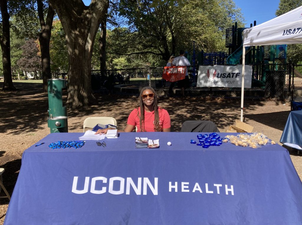 Zoe Green, clinical research assistant at information table.