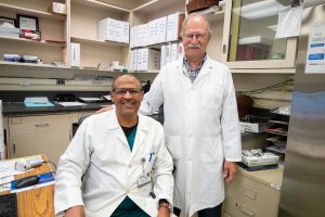 portrait two men in lab coats in lab office setting