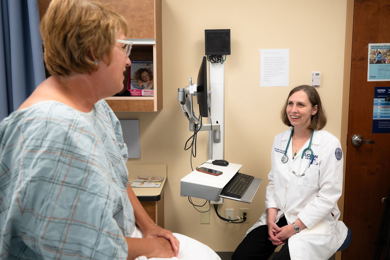 Physician speaking with patient in exam room