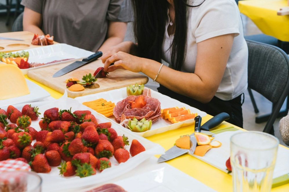 Women cutting fruits and vegetables