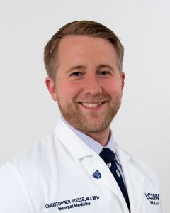 Dr. Christopher Steele studio portrait white coat