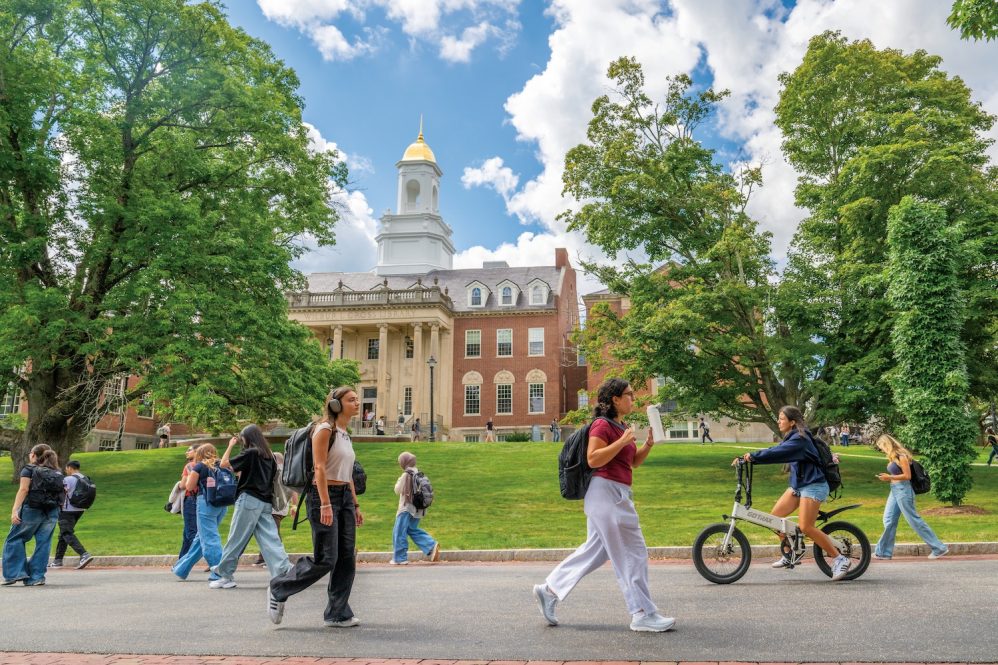 Students walking along the pathway in front of Wilbur Cross