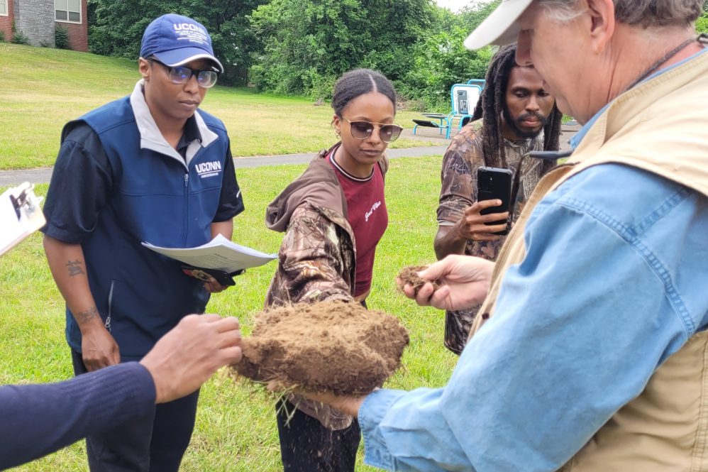 Farmers and Extension educators engaged in hands-on learning