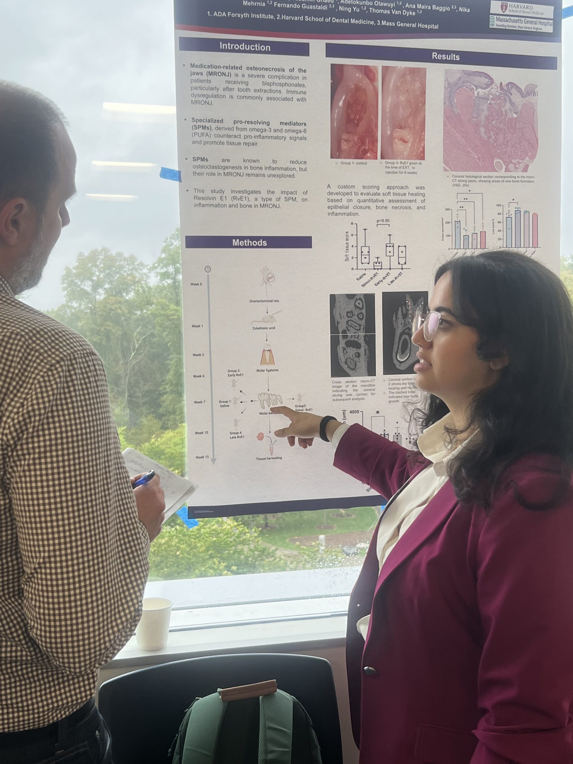 woman shows research poster