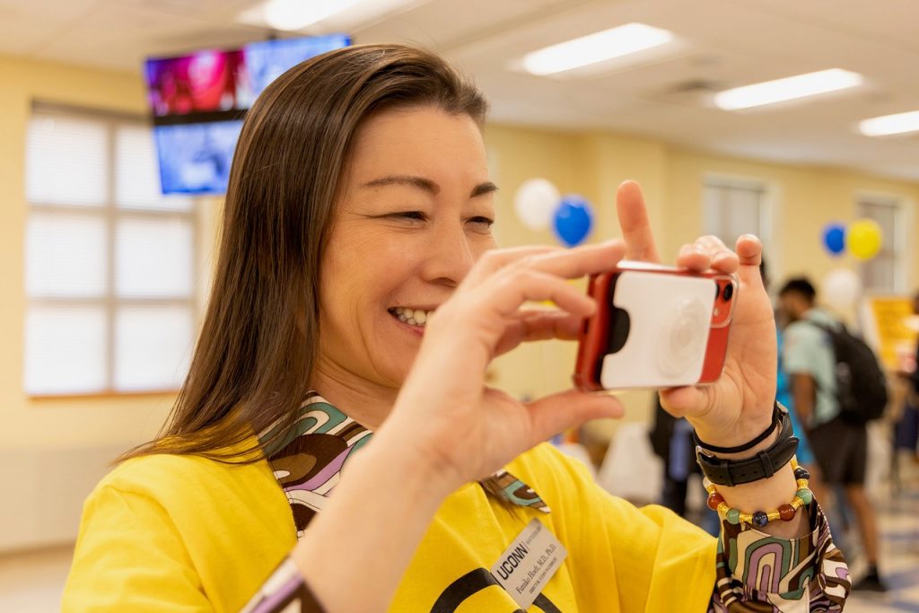 UConn Waterbury Dean Fumiko Hoeft takes a picture with her cell phone.