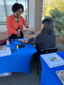 Vaness Bolling, DNP, APRN, FNP-BC, with a patient at a clinic.