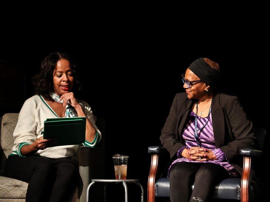 Panelists Dr. Williams and Dr. Dorsey talking on stage.