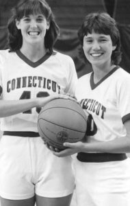two women holding a basketball