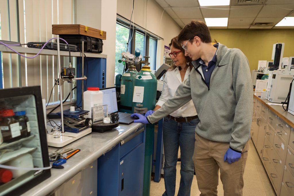 A man and a woman researching zeolite structures in a laboratory.