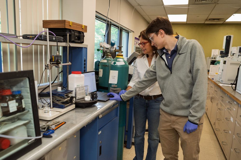 A man and a woman researching zeolite structures in a laboratory.