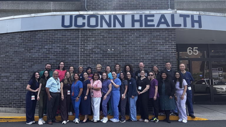 group of dentists posing infront of building