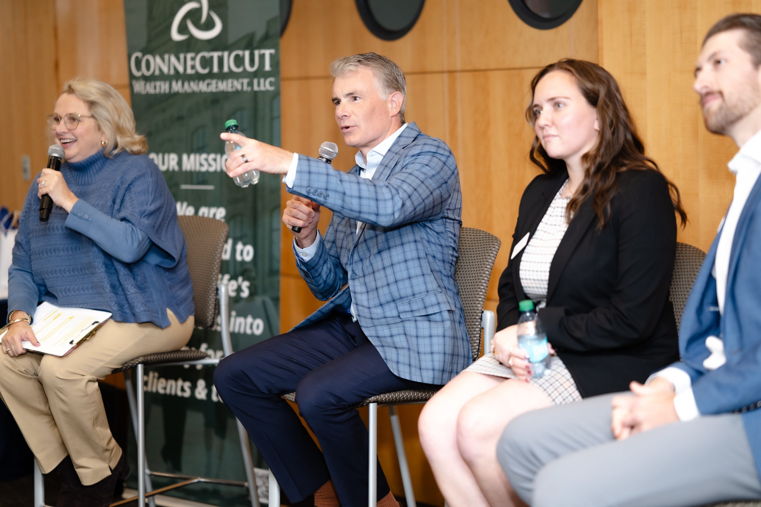 A panel of four people takes questions from an audience.