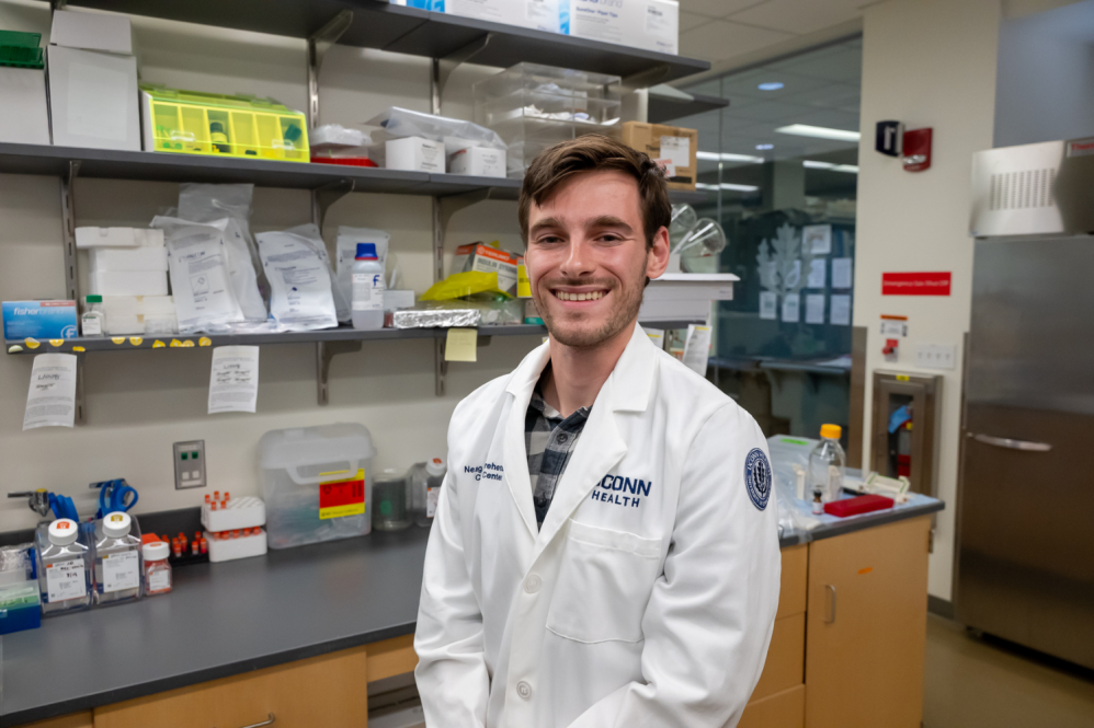 Joe Dempsey standing inDr. Pramod Srivastava’s immunology lab in the Carole and Ray Neag Comprehensive Cancer Center,