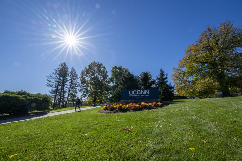 Entryway sign at North Eagleville Road on a fall day.