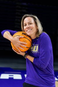 Jelena Pavićević holds basketball.