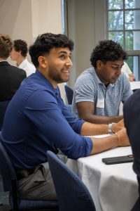 Two students listening to an alum speaker.