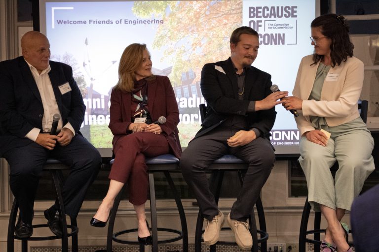 Two older and two younger engineers in a panel discussion